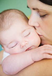Chiropractic care has been shown to improve fertility. Woman with infant child